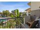 Balcony with seating overlooking a pool and lush tropical landscaping, perfect for relaxation at 200 Maitland Ave # 28, Altamonte Springs, FL 32701