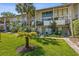 Condominium exterior with well-maintained lawns and lush tropical landscaping creating a serene environment at 200 Maitland Ave # 28, Altamonte Springs, FL 32701