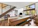 Open-concept living room featuring a large dining table, hardwood floors, staircase, and natural light at 200 Maitland Ave # 28, Altamonte Springs, FL 32701