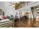 Open-concept living room with wood floors, comfortable seating, and view of the kitchen and loft area at 200 Maitland Ave # 28, Altamonte Springs, FL 32701