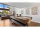 Bright living room featuring hardwood floors, a ceiling fan, and natural light from the large windows at 200 Maitland Ave # 28, Altamonte Springs, FL 32701