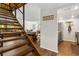 Open-concept living and dining area featuring hardwood floors, modern decor, and staircase access at 200 Maitland Ave # 28, Altamonte Springs, FL 32701