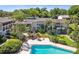 Aerial view of the pool and grill area with landscaping and seating at this condo community at 200 Maitland Ave # 28, Altamonte Springs, FL 32701