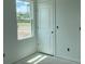 Bedroom with fresh paint, a door, and a large window, allowing natural light to illuminate the space at 2389 Zuni Road, St Cloud, FL 34771