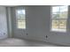 Bright bedroom featuring fresh paint and large windows, allowing natural light to illuminate the space at 2389 Zuni Road, St Cloud, FL 34771