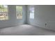 Bright bedroom featuring fresh paint and large windows, allowing natural light to illuminate the space at 2389 Zuni Road, St Cloud, FL 34771