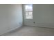 Bright bedroom featuring fresh paint and a large window, allowing natural light to illuminate the space at 2389 Zuni Road, St Cloud, FL 34771