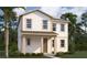 Charming two-story home with a welcoming front porch and beautifully landscaped front yard, showcasing curb appeal at 2389 Zuni Road, St Cloud, FL 34771