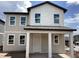 New two story home with covered porch and large windows offering natural light and modern design, new construction at 2389 Zuni Road, St Cloud, FL 34771