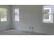 Bright living room with large windows providing natural light and a view of the surrounding neighborhood, ready for personalization at 2389 Zuni Road, St Cloud, FL 34771