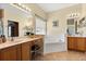 Bathroom featuring double vanities, a large soaking tub, and tile flooring at 24104 Peekskill St, Leesburg, FL 34748
