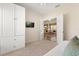 Bedroom with white walls, carpet, and entry to another room at 24104 Peekskill St, Leesburg, FL 34748