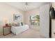 Bright bedroom with a cozy single bed, soft lighting, and a large window at 24104 Peekskill St, Leesburg, FL 34748