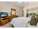 Bedroom with neutral walls, carpet, and a large dresser with mirror at 24104 Peekskill St, Leesburg, FL 34748