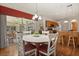 Bright dining area with white table, stylish chairs, and views of the outdoor lanai at 24104 Peekskill St, Leesburg, FL 34748