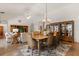 Elegant dining room with a large table, chandelier, and a china cabinet for displaying fine tableware at 24104 Peekskill St, Leesburg, FL 34748