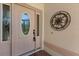 Charming front door featuring decorative glass detailing and a stylish metal accent piece on the exterior at 24104 Peekskill St, Leesburg, FL 34748