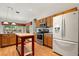 Kitchen featuring wood cabinets, stainless steel appliances, and a moveable kitchen island at 24104 Peekskill St, Leesburg, FL 34748
