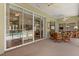 Enclosed lanai showcasing tile flooring, comfortable seating, ceiling fans, and bright natural light at 24104 Peekskill St, Leesburg, FL 34748