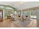 Bright living room with large windows offering pool views, comfortable seating, and a decorative rug at 24104 Peekskill St, Leesburg, FL 34748
