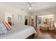 Spacious primary bedroom with wood floors, a sitting area, and access to the bathroom and backyard at 24104 Peekskill St, Leesburg, FL 34748