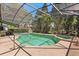 Screened-in pool area with a refreshing in-ground pool and surrounding patio for relaxation and enjoyment at 24104 Peekskill St, Leesburg, FL 34748