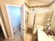 Bright bathroom featuring a glass-enclosed shower, vanity with makeup station and tiled floor at 2426 Hybrid Dr, Kissimmee, FL 34758