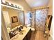 Cozy bathroom featuring a vanity with ample counter space and a shower-tub combo at 2426 Hybrid Dr, Kissimmee, FL 34758