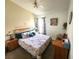 Comfortable bedroom with a floral-patterned bed, natural light, and cozy accents at 2426 Hybrid Dr, Kissimmee, FL 34758