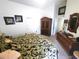 Bright bedroom featuring tropical-themed decor, a large armoire and comfortable furnishings at 2426 Hybrid Dr, Kissimmee, FL 34758