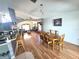 Open dining area adjacent to the kitchen and living spaces featuring wood floors at 2426 Hybrid Dr, Kissimmee, FL 34758