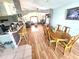 Open dining area featuring wood flooring and an arched entryway to the living room at 2426 Hybrid Dr, Kissimmee, FL 34758