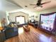 Bright living room featuring wood flooring, large windows, and a comfortable seating area at 2426 Hybrid Dr, Kissimmee, FL 34758