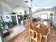 Open concept living space featuring a kitchen, dining area, and living room with stone accent features at 2426 Hybrid Dr, Kissimmee, FL 34758