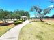 Picturesque view of a serene park area with manicured landscaping, pathways and a gazebo at 2426 Hybrid Dr, Kissimmee, FL 34758