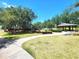 Picturesque view of the park with lush greenery, mature trees, walking paths, and a cozy gazebo at 2426 Hybrid Dr, Kissimmee, FL 34758