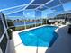 Enjoy the backyard pool with screened enclosure and beautiful water view, perfect for relaxing and entertaining at 2426 Hybrid Dr, Kissimmee, FL 34758