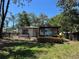 House exterior view showing modern addition with wooden deck and seating at 2520 Park Lake Dr, Deland, FL 32724