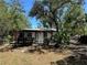 Charming home with decorative pergola and mature trees in a sunny setting at 2520 Park Lake Dr, Deland, FL 32724