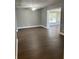 Open-concept living room with ceiling fan and large windows that brighten up the space at 2520 Park Lake Dr, Deland, FL 32724