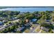 An aerial view shows the home nestled amongst lush trees and close to a picturesque lake at 2614 Rio Ln, Orlando, FL 32805