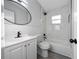 Updated bathroom featuring modern lighting, a vanity, a toilet, a bathtub and attractive tile at 2614 Rio Ln, Orlando, FL 32805