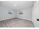 Bedroom with two windows, light gray walls, light-colored wood-look flooring, and a closet at 2614 Rio Ln, Orlando, FL 32805