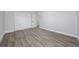 Bedroom featuring gray walls, light-colored wood-look flooring, and a door to a closet at 2614 Rio Ln, Orlando, FL 32805