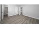 Bedroom showcasing gray walls, light-colored wood-look flooring, and doors to a bathroom and closet at 2614 Rio Ln, Orlando, FL 32805