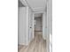 Hallway featuring neutral walls, gray wood flooring, and multiple doorways at 2614 Rio Ln, Orlando, FL 32805