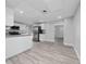Bright kitchen area with stainless steel appliances, gray wood flooring, and an open floorplan at 2614 Rio Ln, Orlando, FL 32805