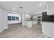 Spacious kitchen area with stainless steel appliances, gray wood flooring, and granite countertops at 2614 Rio Ln, Orlando, FL 32805