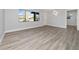 Bright living room featuring neutral walls, gray wood flooring, and a large window at 2614 Rio Ln, Orlando, FL 32805
