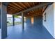 Covered patio featuring a gray floor and columns, a wood-paneled roof, and a yellow door at 2614 Rio Ln, Orlando, FL 32805